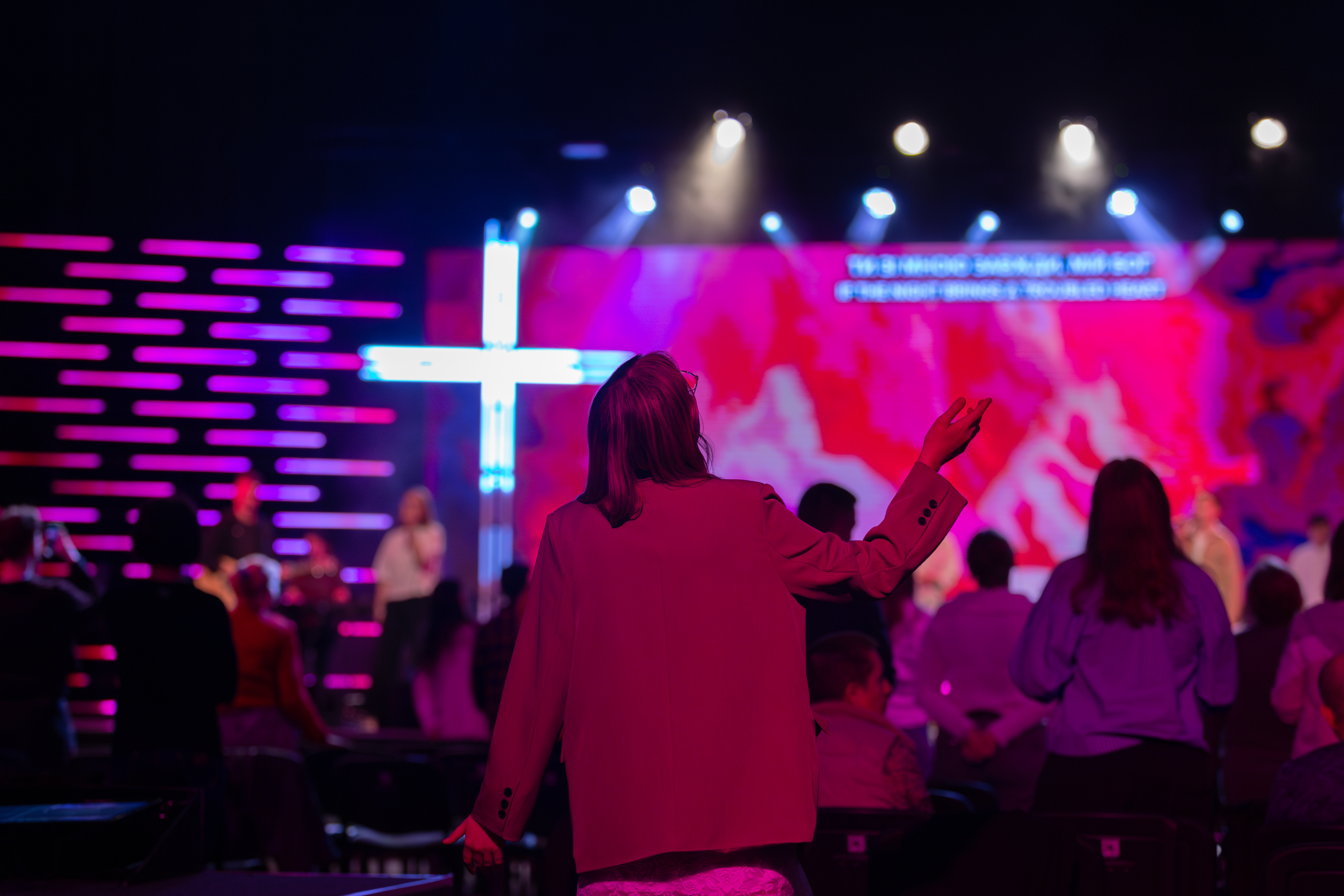 Modern church worship with neon cross